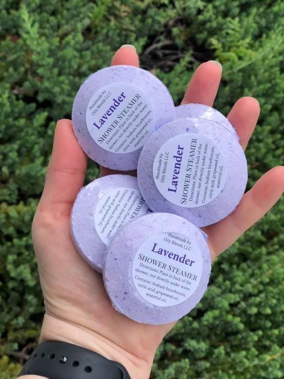 Person holding lavender shower steamers in the palm
